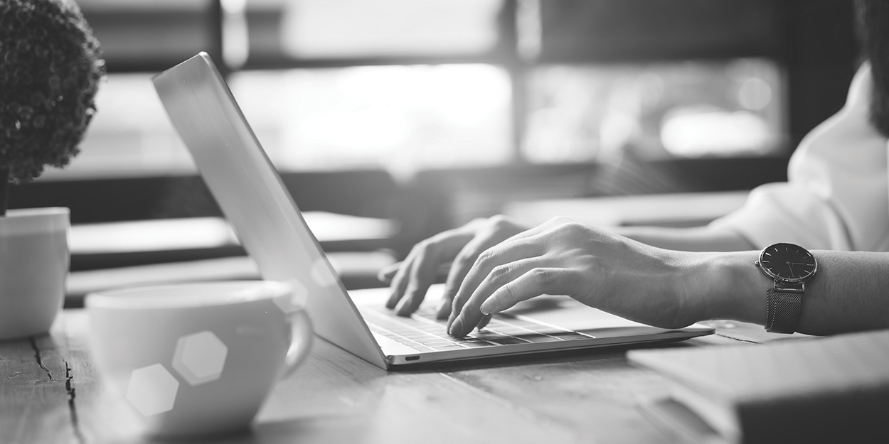 female hands typing on a laptop